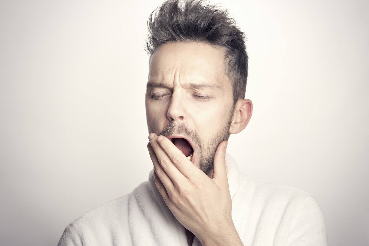 A person lying awake in bed at night staring at the ceiling, representing insomnia disorder