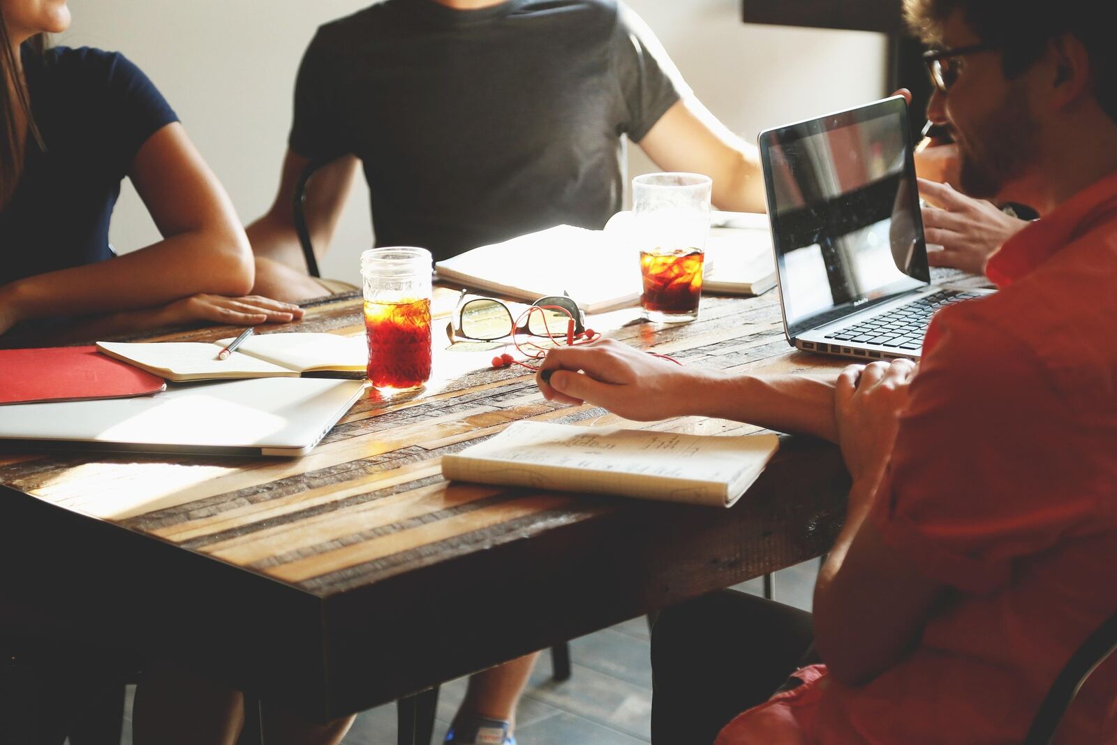 Group of people in a meeting representing how society and community shape mental health outcomes